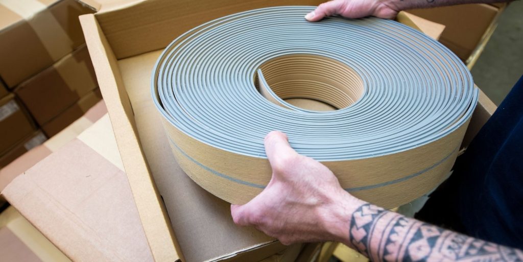 Flexiteek coil being packaged into a box ready for shipping - Flexiteek International